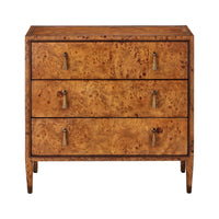A three-drawer wooden chest of drawers with an intricate burl wood grain pattern in warm golden-brown tones, featuring small metal pull handles and tapered legs, shown against a plain white background.