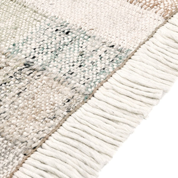 Close-up of a textured rug with fringe detail