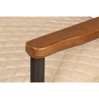 close up wood armchair rest beige quilted seat leather