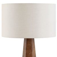 Table lamp with a wooden base and white fabric shade on a white background