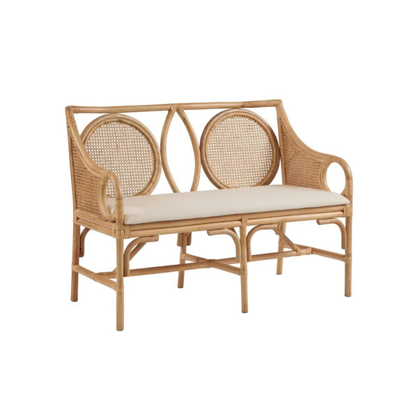 Wicker bench with cream cushion on a white background