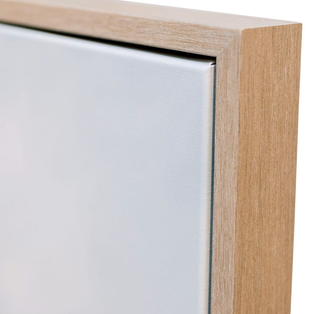 Close-up of a wooden picture frame corner on a white background