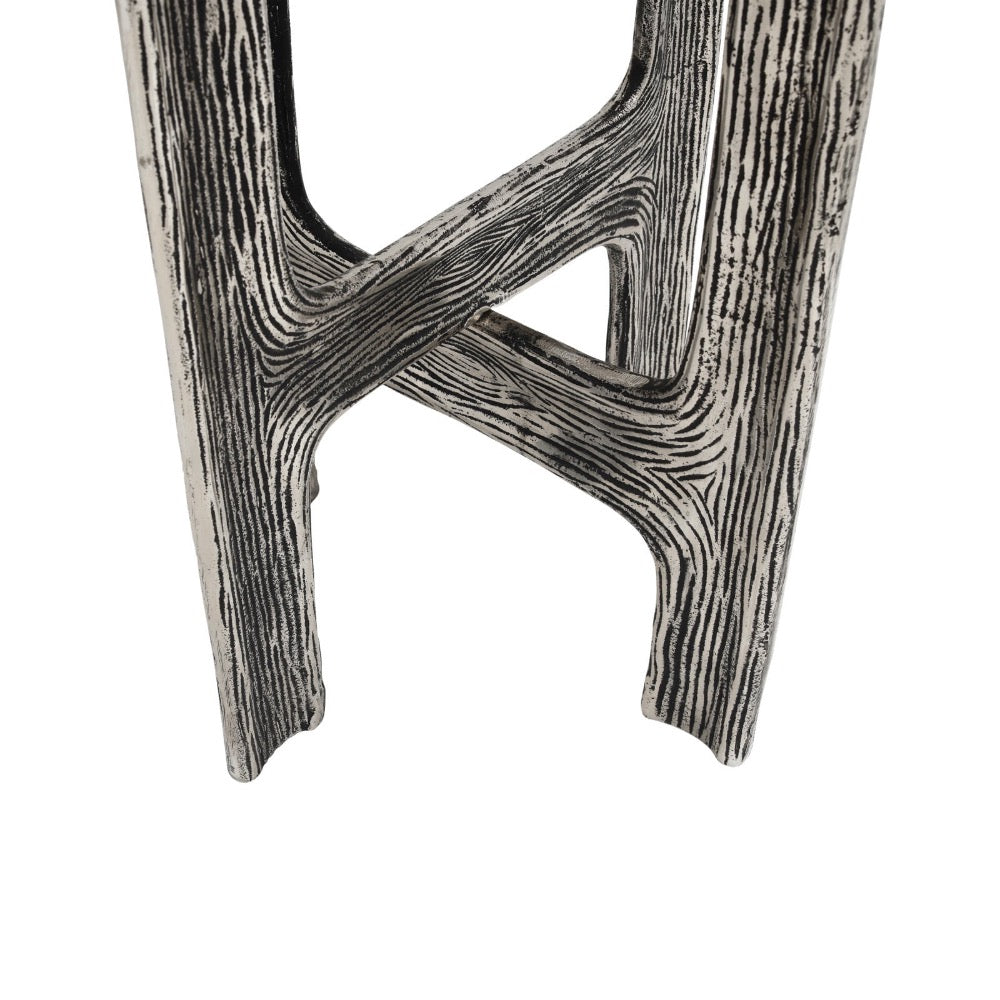 A close-up of  accent table legs with a distressed, wood-grain textured finish in black and white, set against a plain white background.