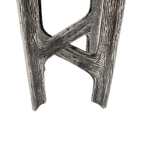 A close-up of  accent table legs with a distressed, wood-grain textured finish in black and white, set against a plain white background.