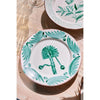 Two Casa Nuno Green Palm Dinner Plates by Abigails rest on a light wooden table.