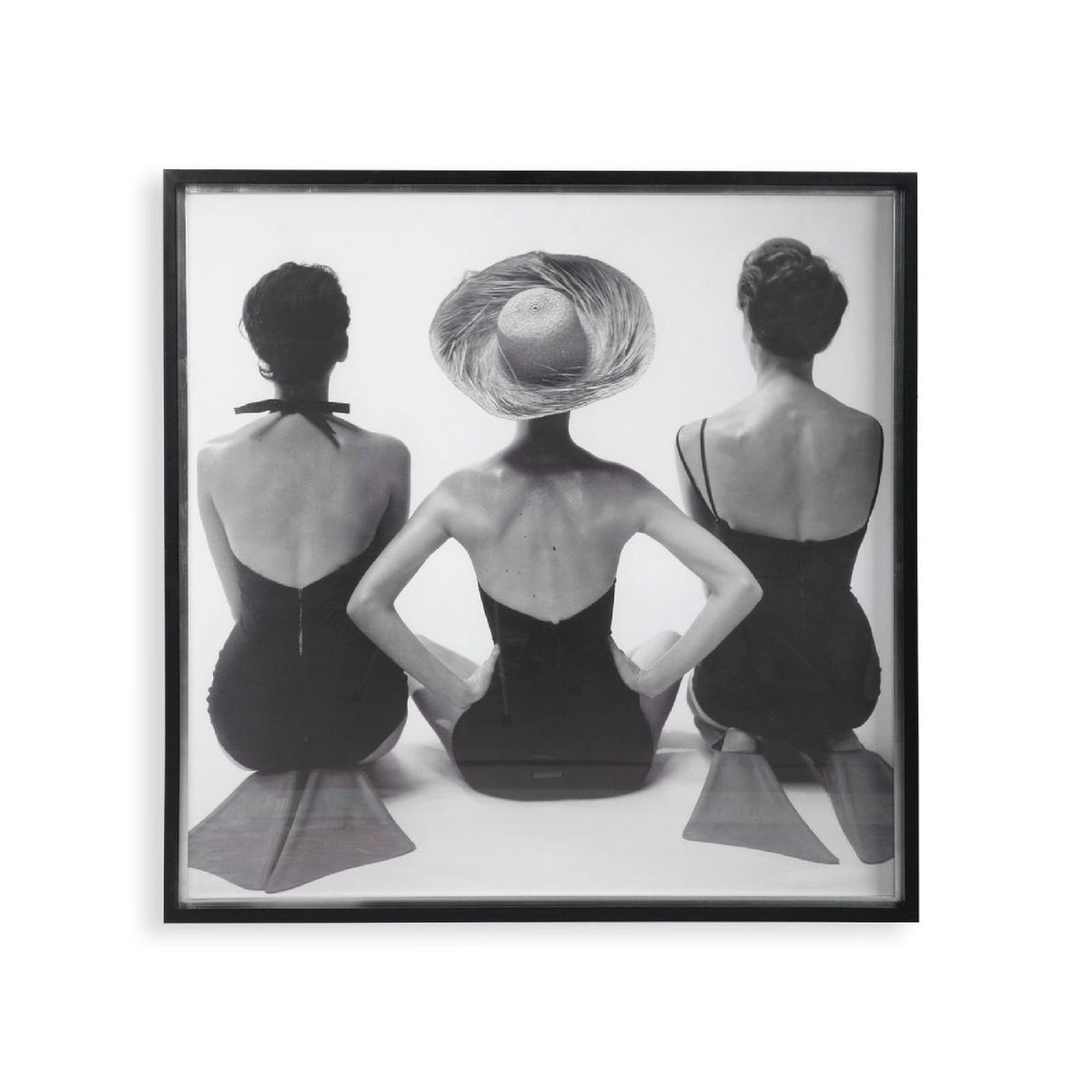 Framed black and white art print of three women sitting with their backs to the viewer.
