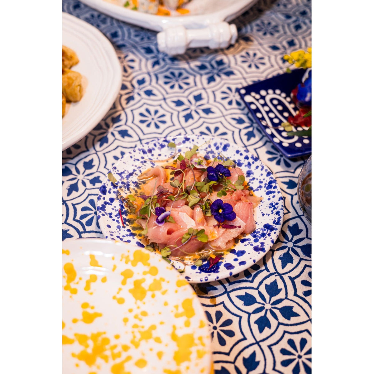 Sashimi with microgreens and edible flowers on an Abigails Beach Chic Cabana Tablecloth.