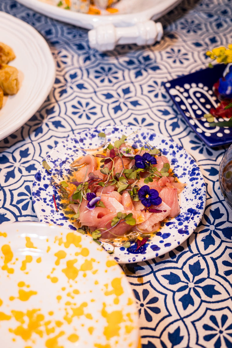 Sashimi with microgreens and edible flowers on an Abigails Beach Chic Cabana Tablecloth.