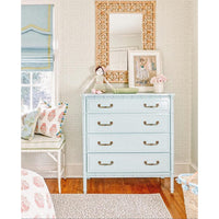 rattan wall mirror over dresser