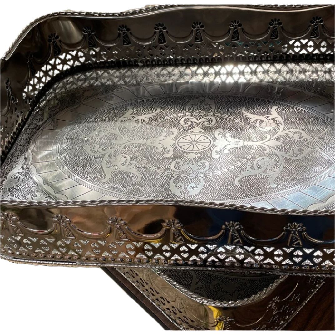 Close-up of Abigails Polished Nickel Embossed Large Trays, handmade in Italy and stacked with ornate edges.