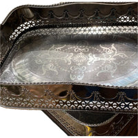 Close-up of Abigails Polished Nickel Embossed Large Trays, handmade in Italy and stacked with ornate edges.