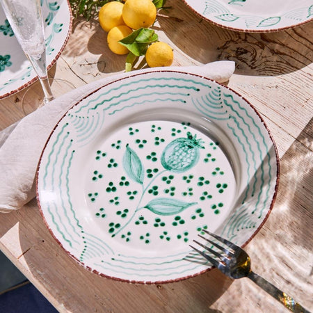 Abigails Casa Nuno Green Dinner Plates (set of 2) with a floral design are displayed on a wooden table with lemons.
