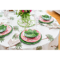Table set with floral plates, green leaf bowls, and Abigails' Compagnia Green Oak Leaf Charger on a leafy tablecloth.