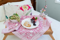 Breakfast tray with food on a bed