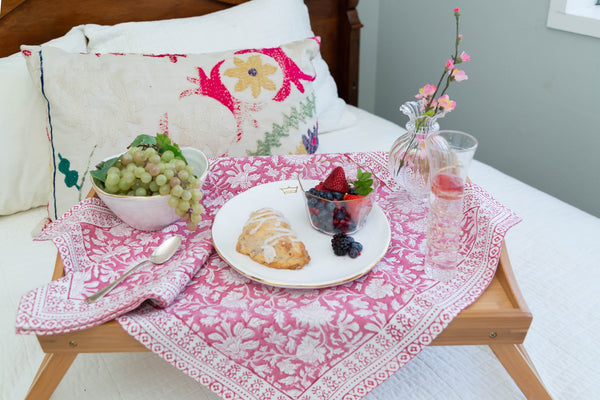 Breakfast tray with food on a bed