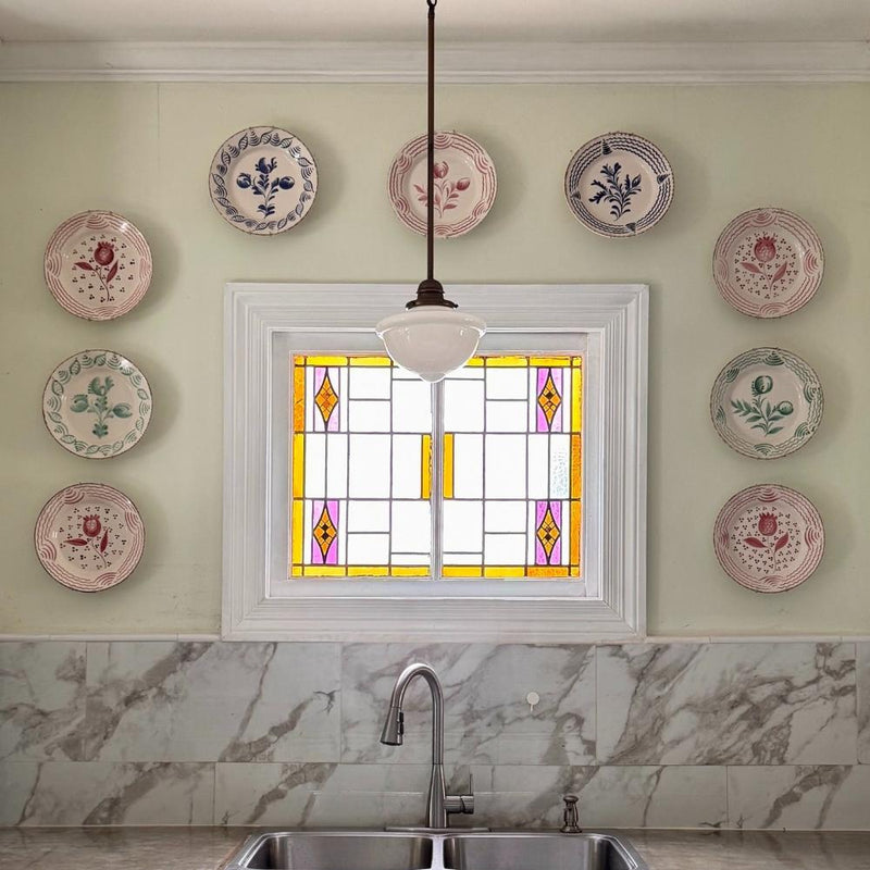 Kitchen wall featuring Abigails Casa Nuno Green Dinner Plates (set of 2) above a marble backsplash and sink.
