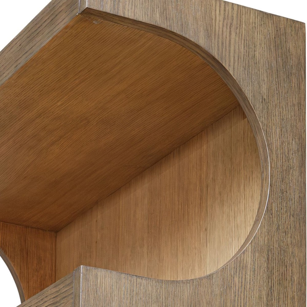 Close-up of the Osrick Etagere by Uttermost, featuring a large circular cutout and elegant wood grain texture.