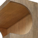 Close-up of the Osrick Etagere by Uttermost, featuring a large circular cutout and elegant wood grain texture.