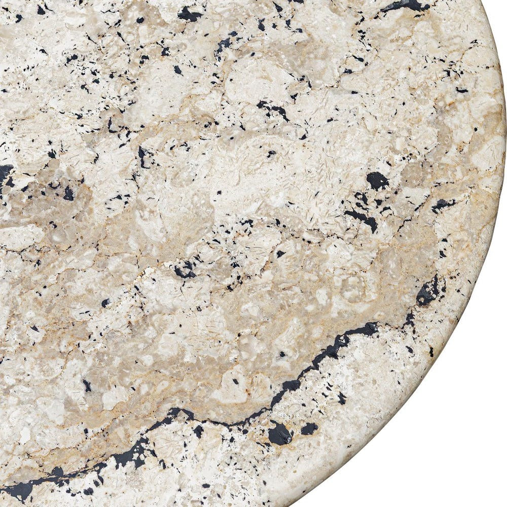 Close-up of a beige marble surface with black speckles