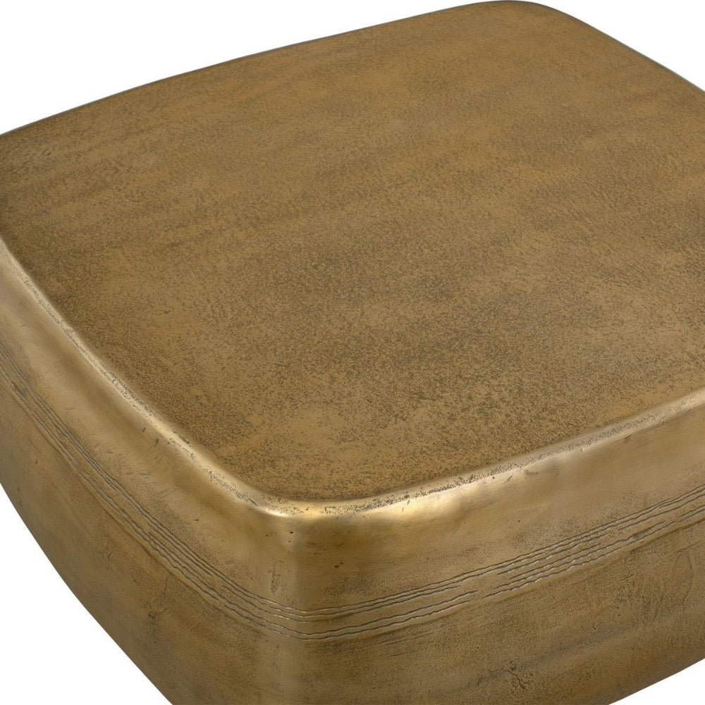 Close up gold coffee table with a textured surface on a white background