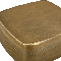 Close up gold coffee table with a textured surface on a white background
