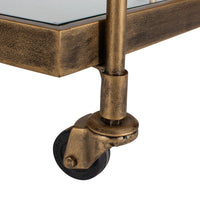 Close-up of a bronze-finished metal bar cart leg with a wheel on a white background