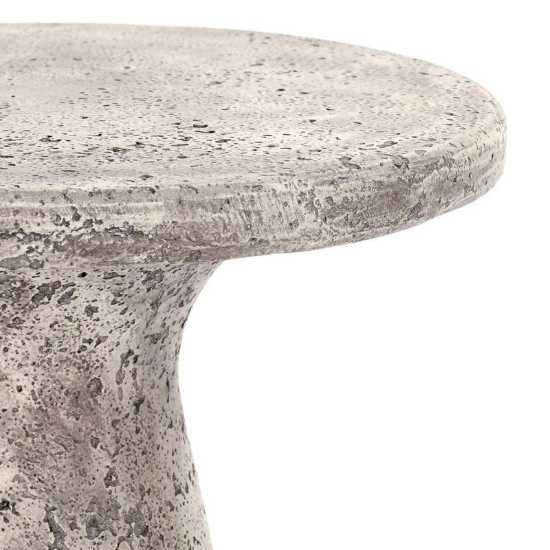 Close-up of Classic Home's Collins Concrete Accent Table in rust—its speckled finish is perfect for outdoor spaces.