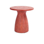 The Collins Concrete Accent Table by Classic Home features a rust color and stylish shape—ideal for outdoor spaces.