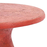 Close-up of the Collins Concrete Accent Table by Classic Home in rust, featuring a round top and curved base against white.