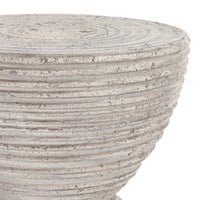 Close-up of the Corey Outdoor Accent Table by Classic Home—textured, round, and ideal for patios or porches.