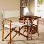 tortoise shell bamboo fold out chair and magazine holder table in a neutral room