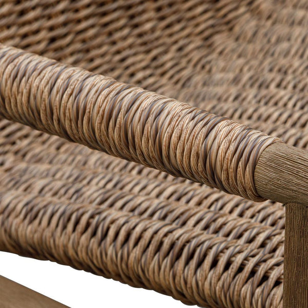 Close-up of a wicker chair with a focus on the woven pattern.