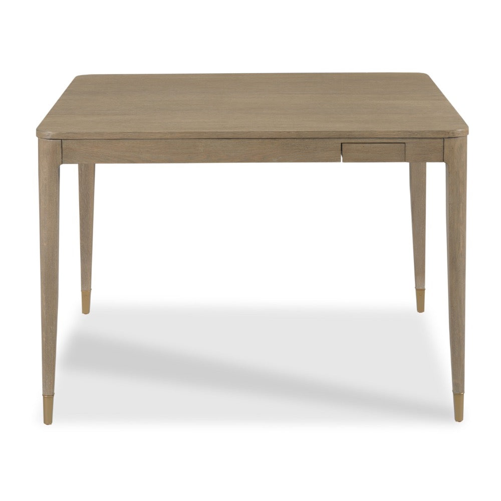 A rectangular wooden table with a light beige finish, featuring tapered legs and a small drawer on the front right side, shown against a plain white background.