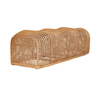 A natural woven rattan or wicker bench with a curved, elongated shape, shown on a plain white background.
