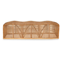 A natural woven rattan or wicker bench with a curved, domed top and open lattice construction, shown against a plain white background.