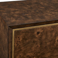 Close-up of a dark brown burl wood cabinet or sideboard with a brass or gold metal trim accent along the edge.