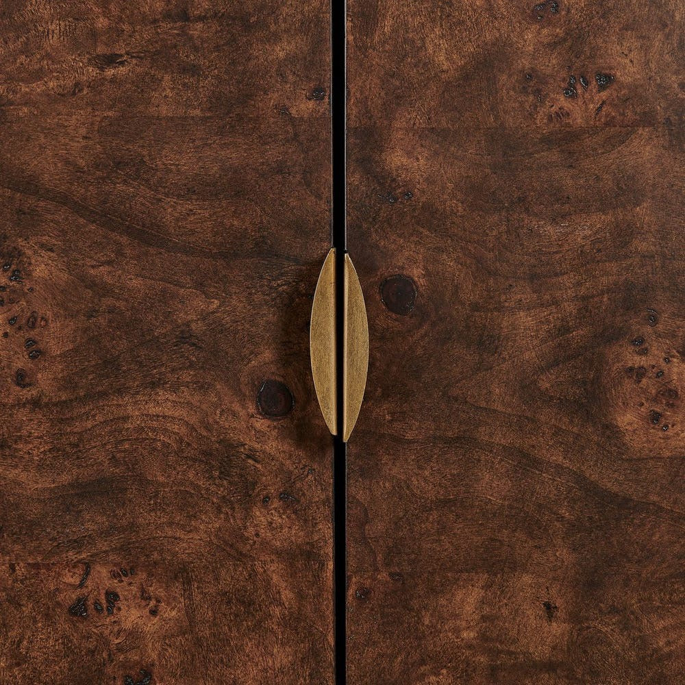 A close-up of a dark brown wood cabinet door with a vertical center seam and a single elongated brass handle in the middle.