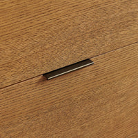 Metal handle on a wooden surface