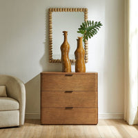 Wooden dresser with three drawers, two vases, and a mirror in a room setting.