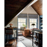 Cozy attic office with wood ceiling, two windows, desk, lamp, and Woodbridge Furniture Revival Counter Stools.