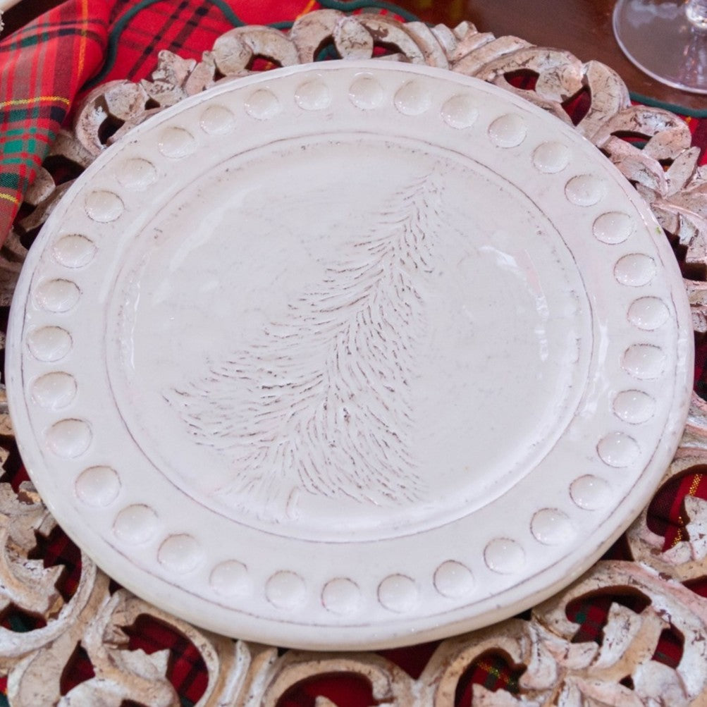 Decorative white plate with embossed design on a decorative stand