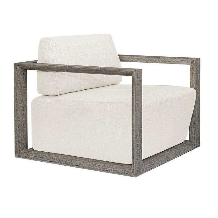 Uttermost Remsen Outdoor Lounge Chair with weathered gray frame and white cushions, shown at an angle.