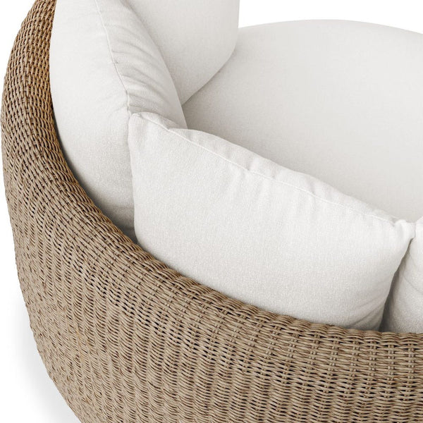 Wicker chair with white cushions on a white background