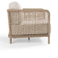 Woven chair with beige cushion on a white background