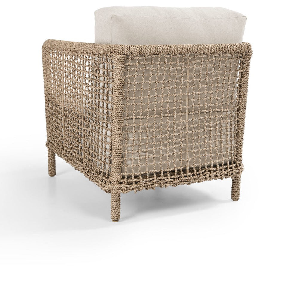 Woven chair with a beige cushion on a white background