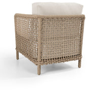 Woven chair with a beige cushion on a white background