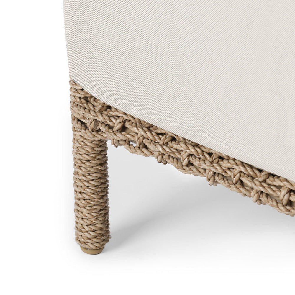 Close-up of a chair with woven legs on a white background