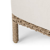 Close-up of a chair with woven legs on a white background