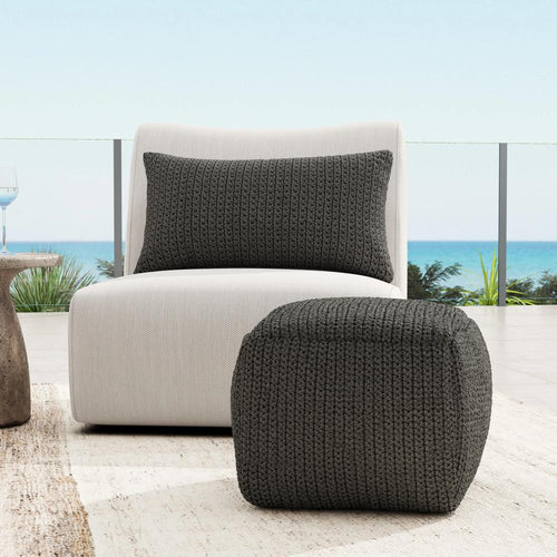 The Atlas Outdoor Swivel Chair by Classic Home features a wide seat, curved back, and fade-resistant fabric in light gray.