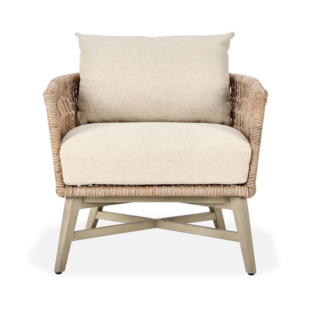 Wicker armchair with beige cushions on a white background